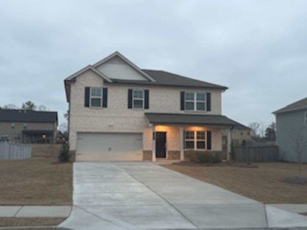 a front view of a house with yard