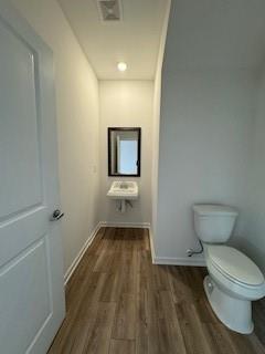309 Amsterdam Way Hampton, GA 30228 - Photo 5 of 53 a bathroom with a toilet and a hardwood