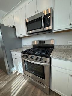 309 Amsterdam Way Hampton, GA 30228 - Photo 8 of 53 a stove top oven sitting inside of a kitchen