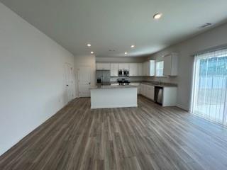 309 Amsterdam Way Hampton, GA 30228 - Photo 9 of 53 a view of kitchen with wooden floor and electronic appliances