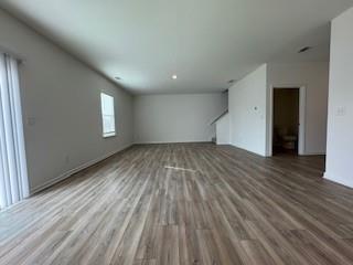 309 Amsterdam Way Hampton, GA 30228 - Photo 10 of 53 a view of empty room with window and wooden floor