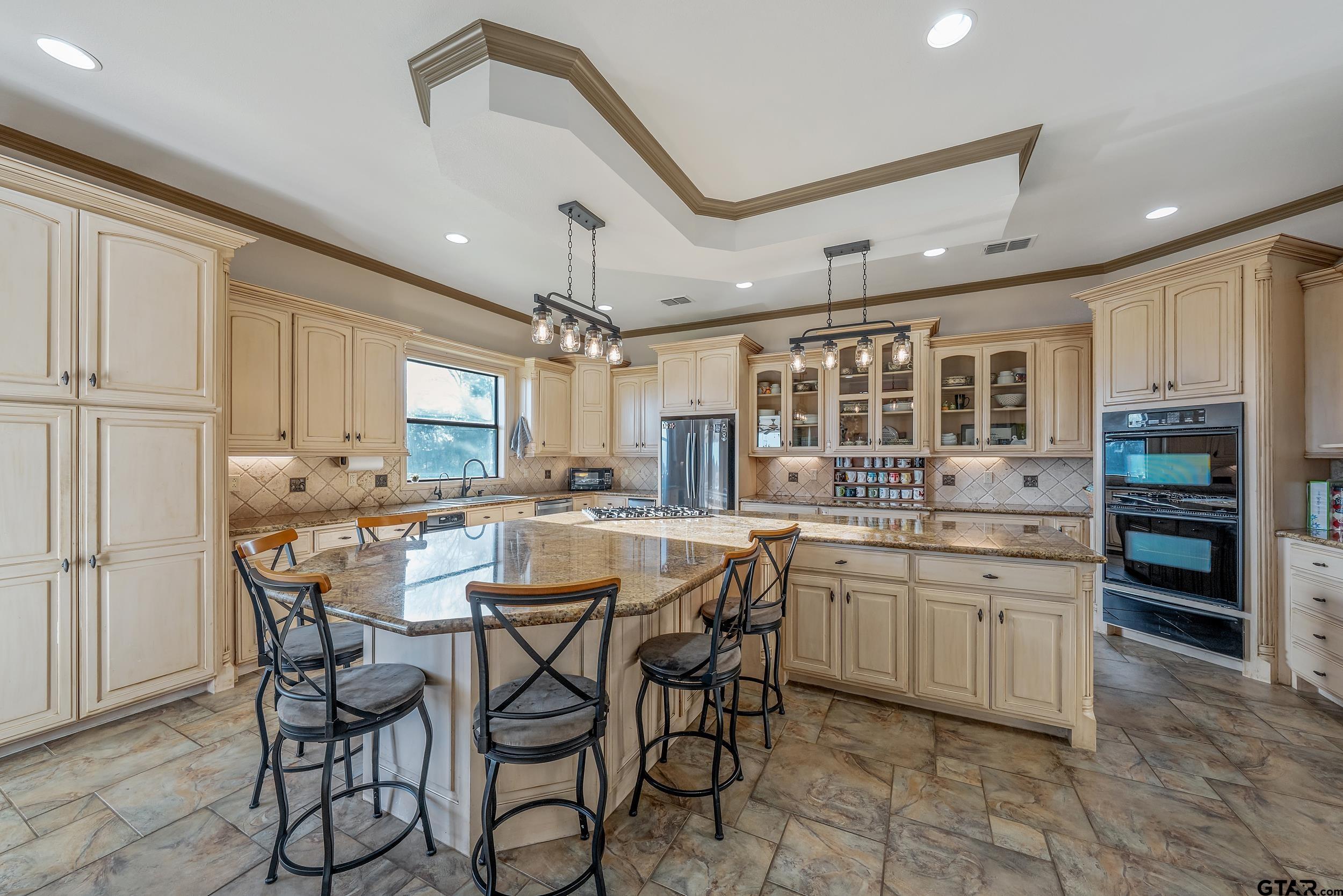 488 VZ County Road Ben Wheeler, TX 75754 - Photo 37 of 47 a kitchen with a dining table chairs cabinets and stainless steel appliances