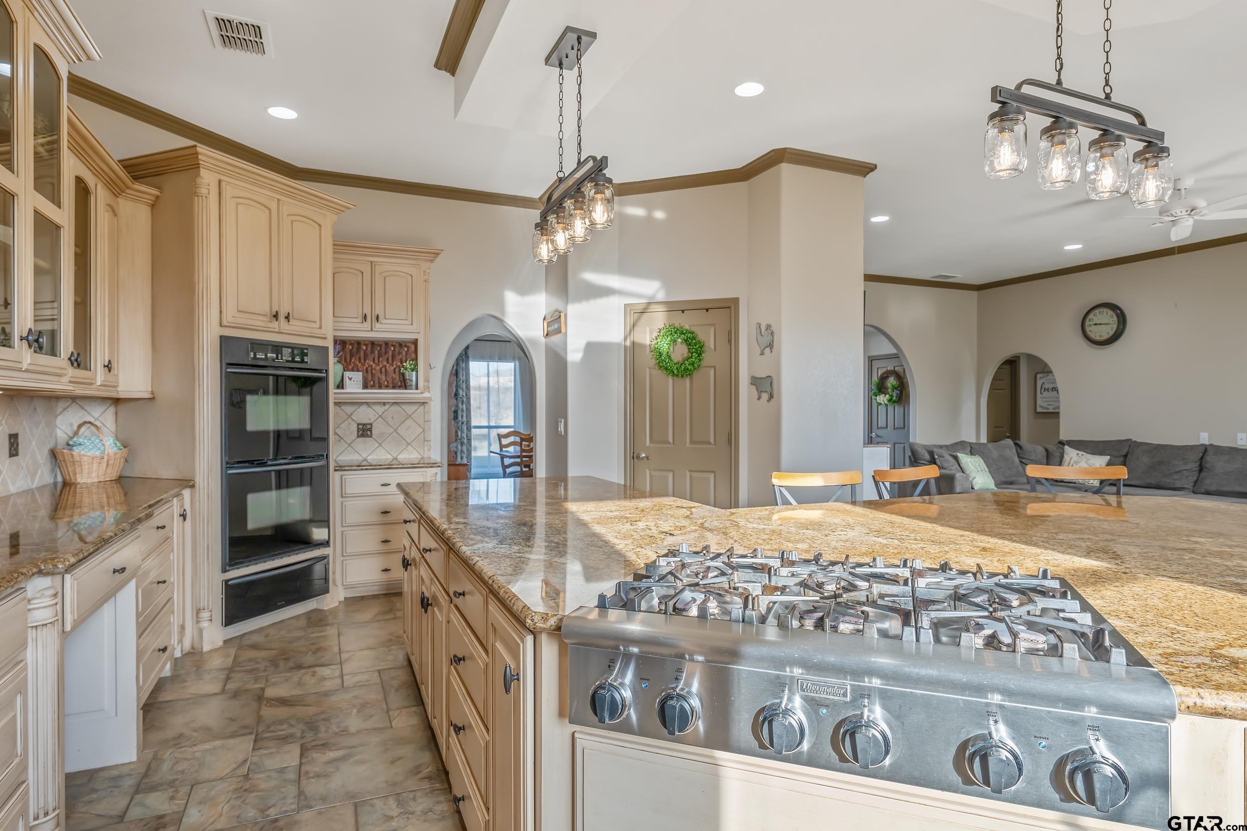 488 VZ County Road Ben Wheeler, TX 75754 - Photo 38 of 47 a kitchen with stainless steel appliances kitchen island granite countertop a stove and cabinets