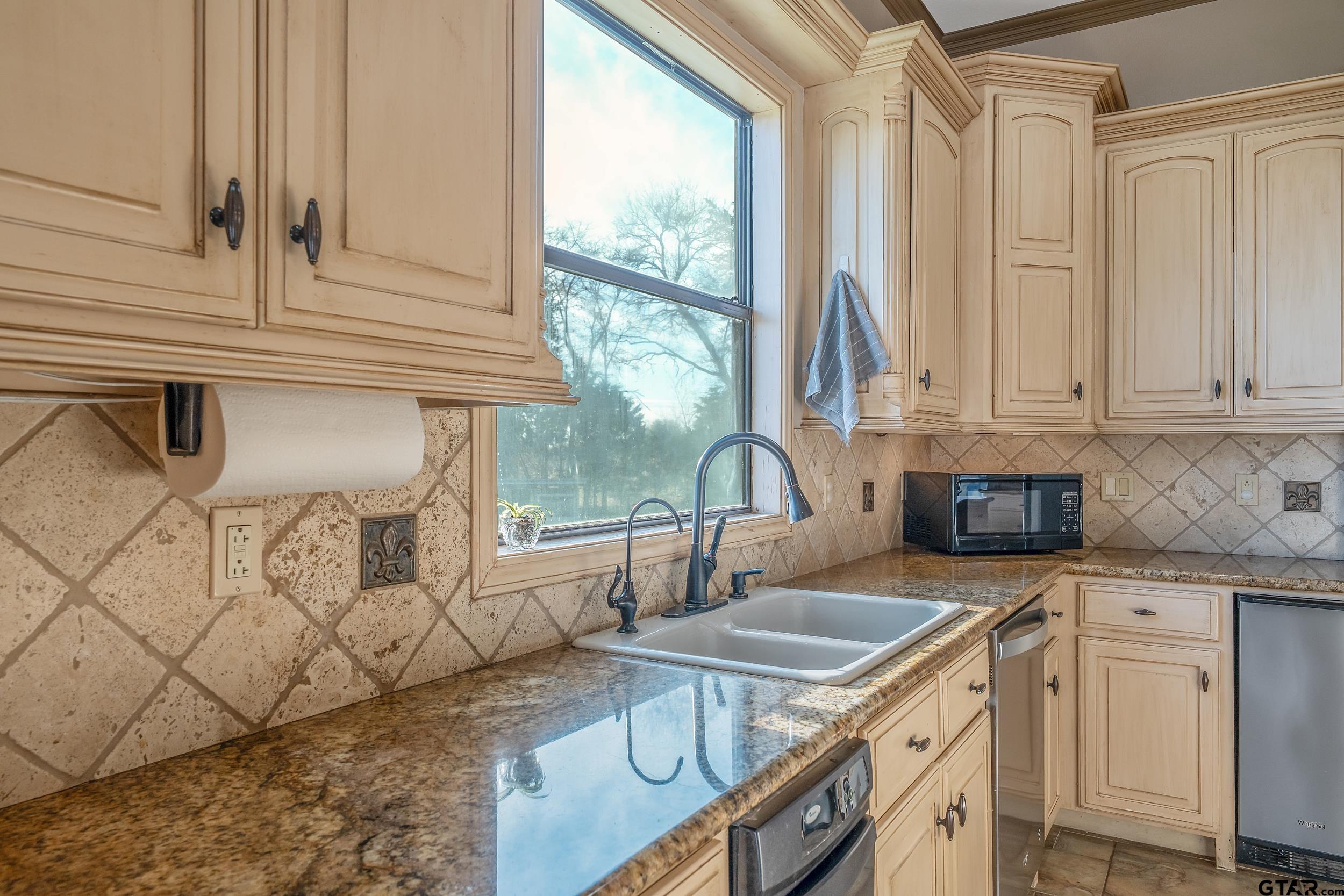 488 VZ County Road Ben Wheeler, TX 75754 - Photo 39 of 47 a kitchen with granite countertop a sink a stove and cabinets
