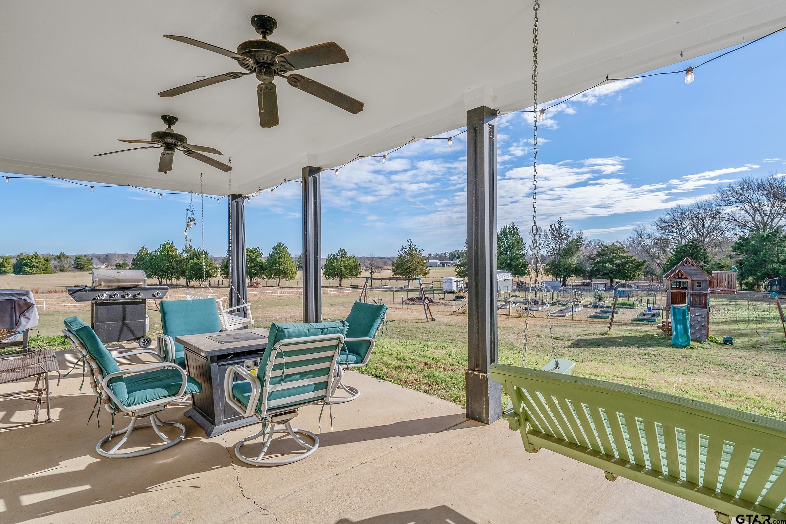 488 VZ County Road Ben Wheeler, TX 75754 - Photo 9 of 47 a view of a patio with a table chairs and a floor to ceiling window