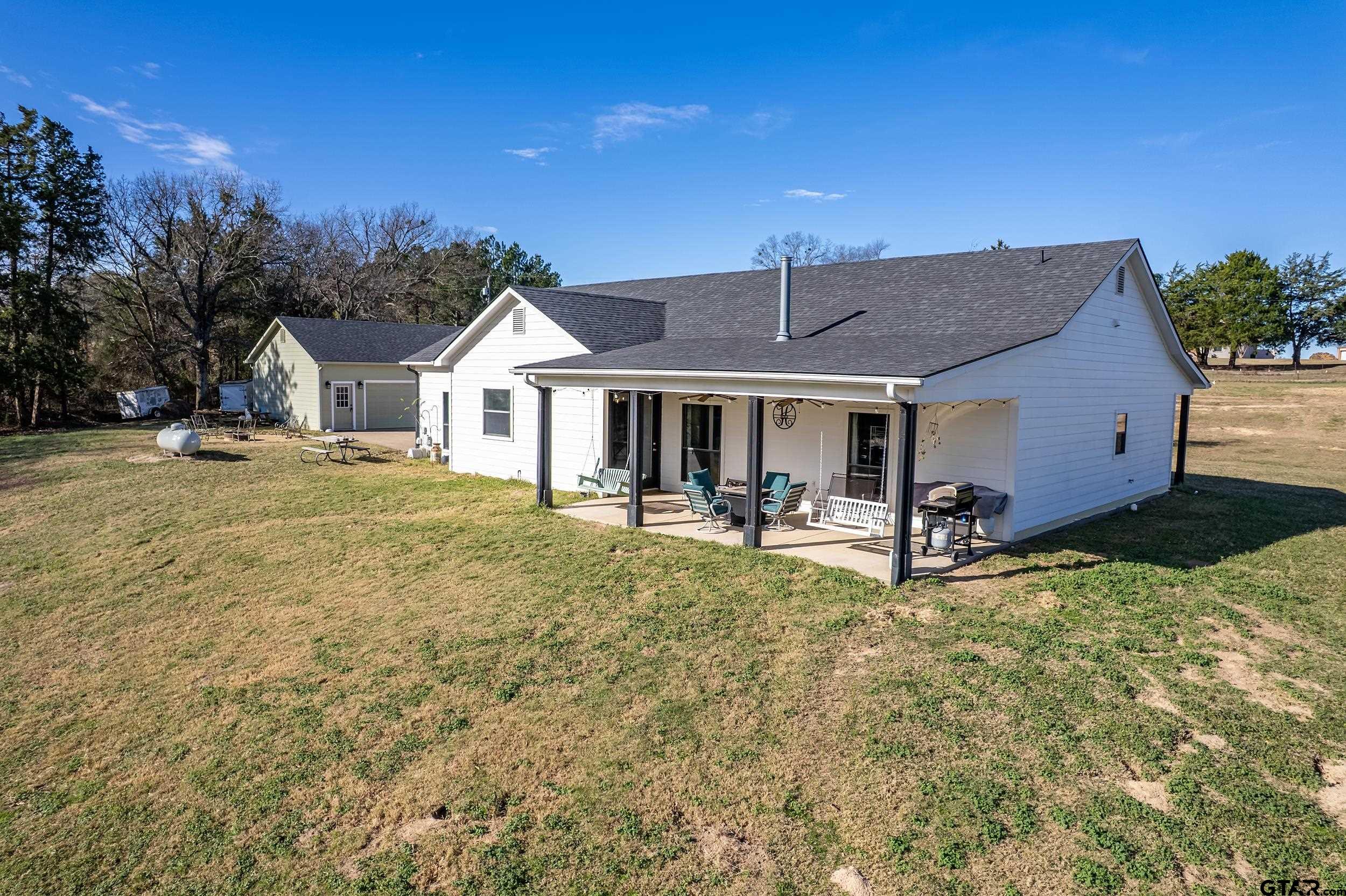 488 VZ County Road Ben Wheeler, TX 75754 - Photo 10 of 47 a front view of a house with swimming pool having outdoor seating