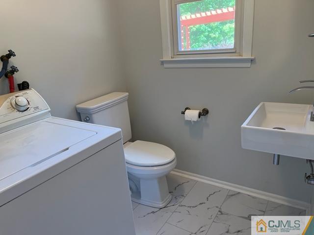 39 Bristol Road Piscataway, NJ 08854 - Photo 18 of 18 a white toilet sitting next to a bathroom sink