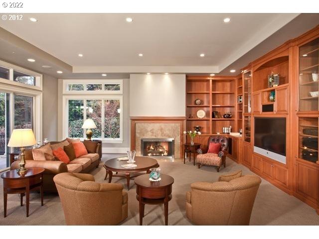1186 Crestline Court Lake Oswego, OR 97034 - Photo 9 of 21 a living room with furniture a fireplace and a floor to ceiling window