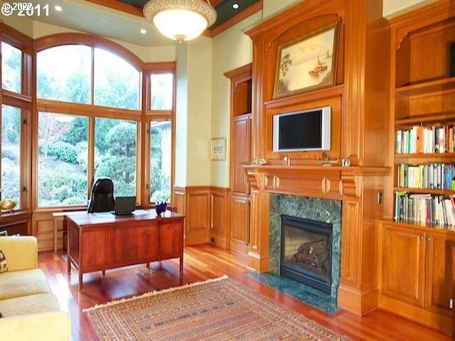 1186 Crestline Court Lake Oswego, OR 97034 - Photo 10 of 21 a living room with fireplace furniture and a floor to ceiling window