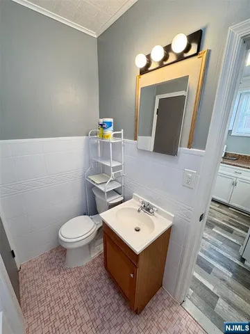 a bathroom with a sink a toilet and mirror