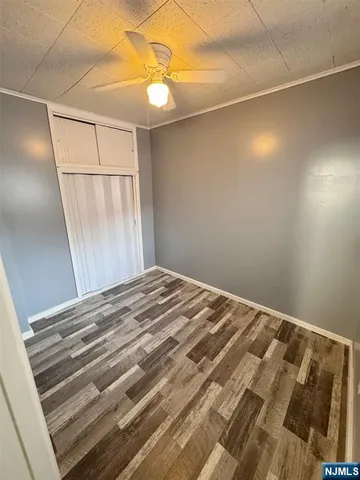 a view of a room with wooden floor and window