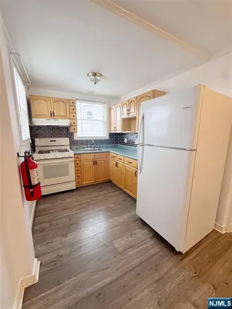 a kitchen with wooden cabinets and white appliances