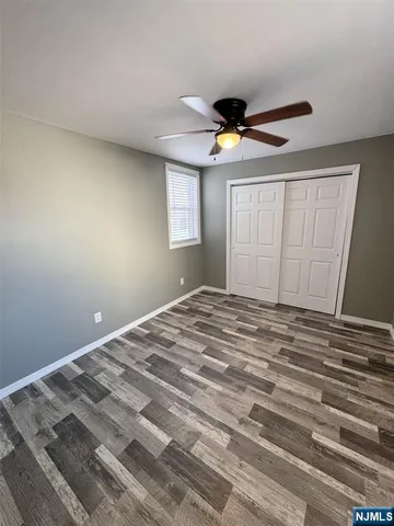 a bedroom with a bed and a ceiling fan
