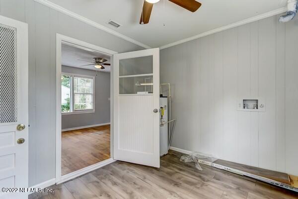 1752 Lilly Road East Jacksonville, FL 32207 - Photo 25 of 31 an empty room with wooden floor cabinet and windows