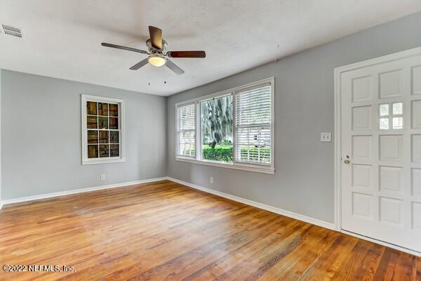 1752 Lilly Road East Jacksonville, FL 32207 - Photo 5 of 31 a view of an empty room with wooden floor and a window