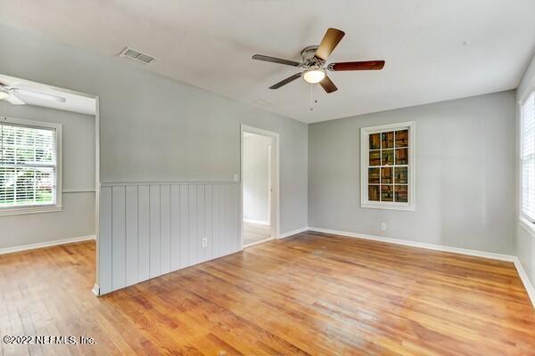 1752 Lilly Road East Jacksonville, FL 32207 - Photo 7 of 31 a view of empty room with wooden floor and fan