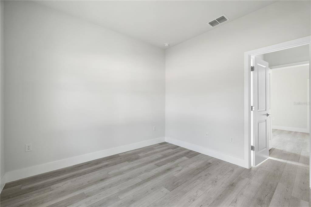 16281 Southwest 48th Circle Ocala, FL 34473 - Photo 17 of 26 an empty room with wooden floor