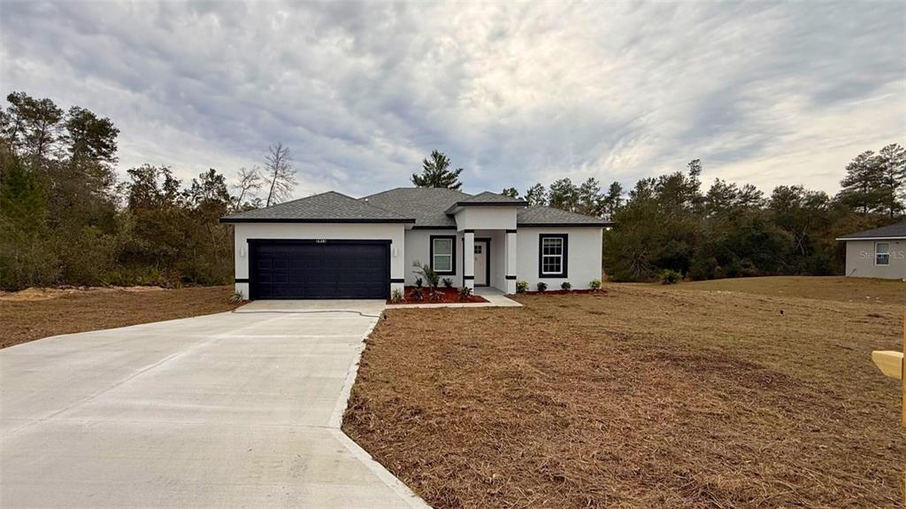 16281 Southwest 48th Circle Ocala, FL 34473 - Photo 2 of 26 front view of a house with a yard