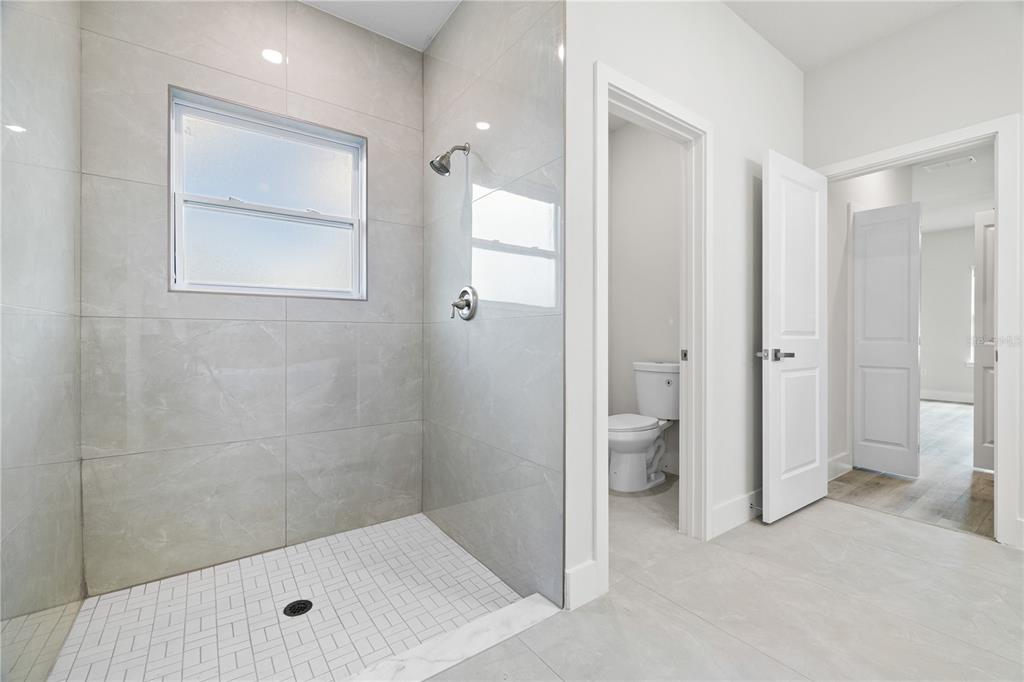 16281 Southwest 48th Circle Ocala, FL 34473 - Photo 25 of 26 a bathroom with a shower and a toilet