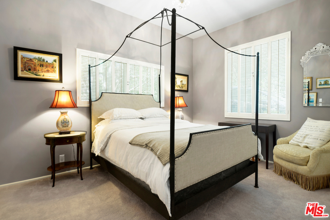 1077 Stradella Road Los Angeles, CA 90077 - Photo 17 of 25 a bedroom with a bed and window
