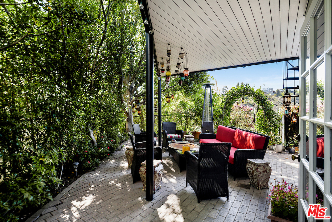 1077 Stradella Road Los Angeles, CA 90077 - Photo 21 of 25 an outdoor sitting area with couch and a potted plant