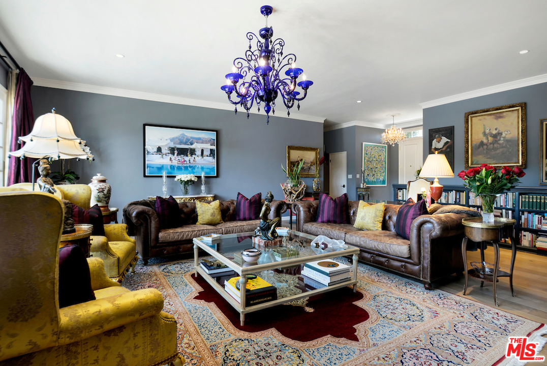 1077 Stradella Road Los Angeles, CA 90077 - Photo 4 of 25 a living room with furniture a chandelier and a rug