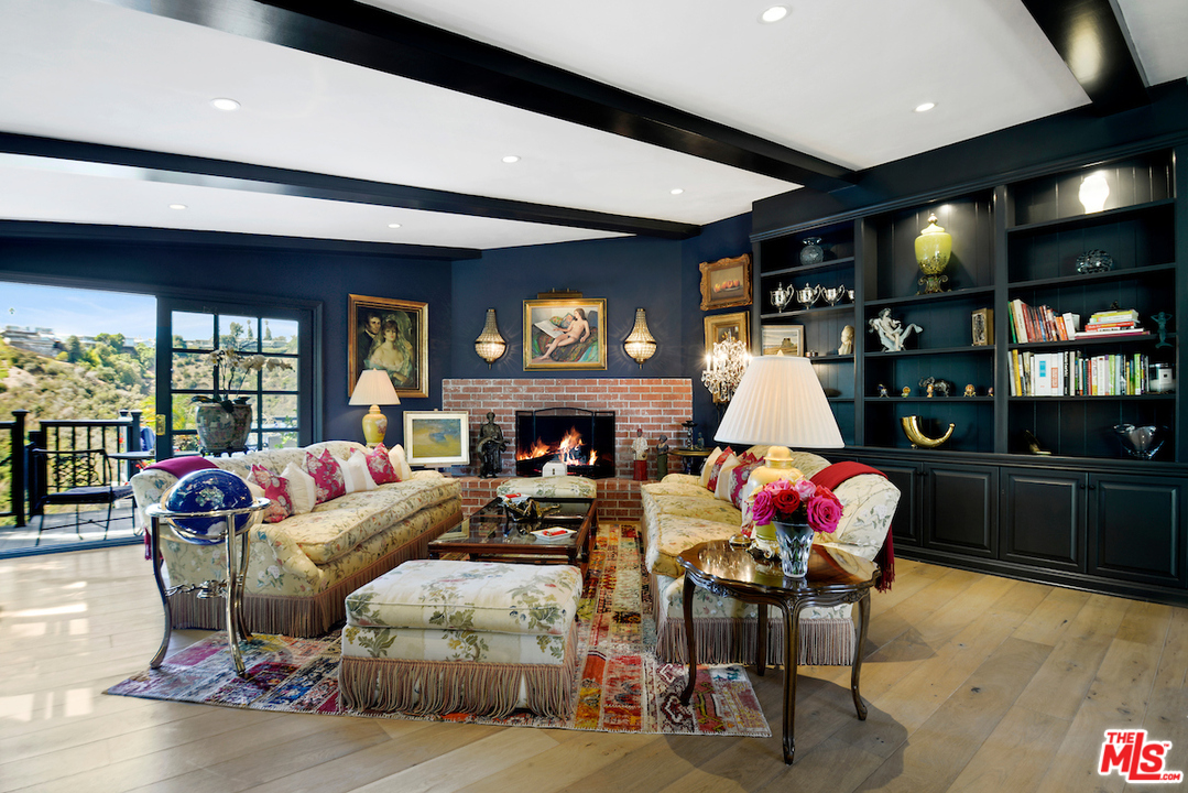 1077 Stradella Road Los Angeles, CA 90077 - Photo 6 of 25 a living room with furniture and a fireplace