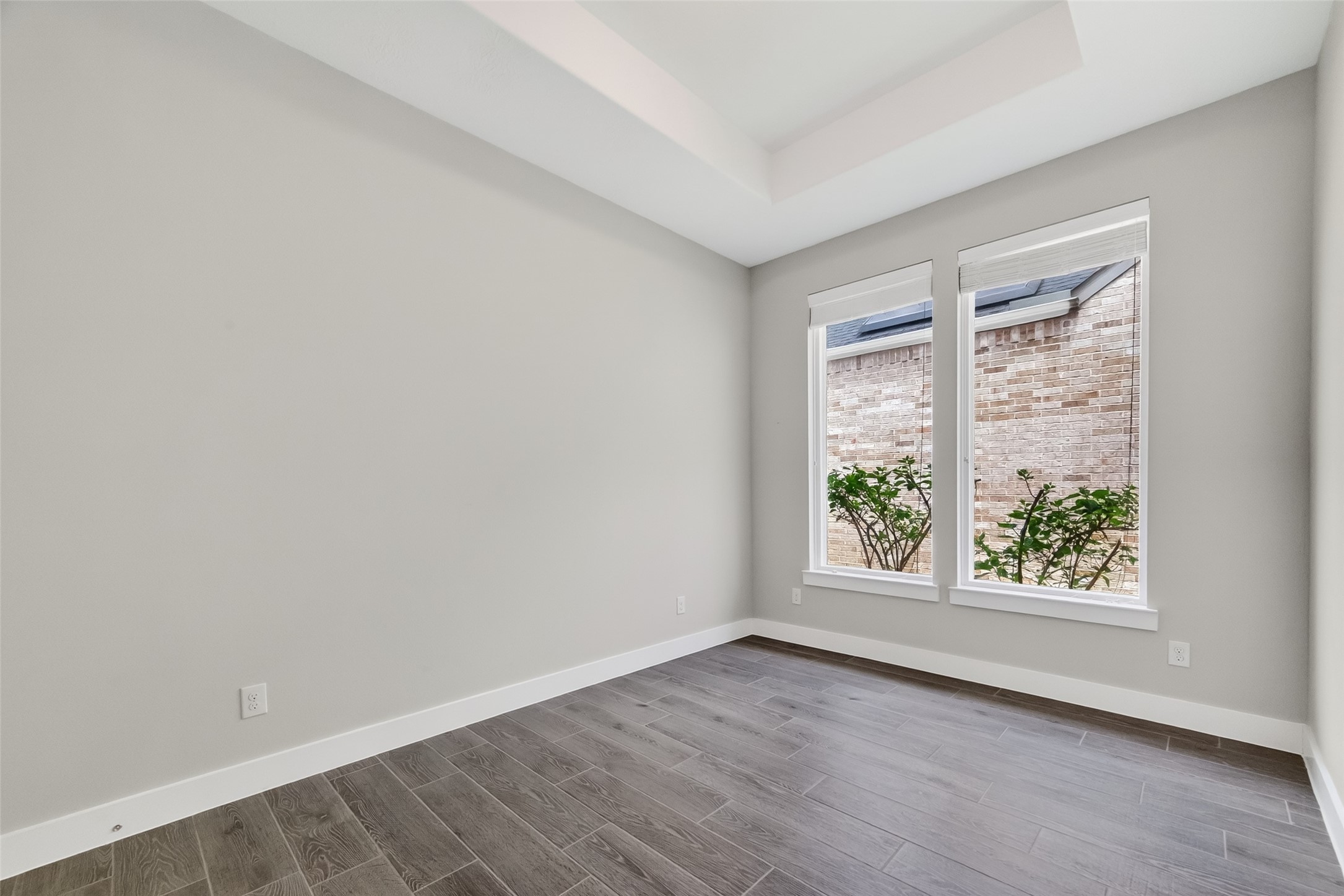 3415 Mckinney Ridge Drive Houston, TX 77059 - Photo 18 of 43 Two large windows provide natural light and a view of the flowering native bushes.