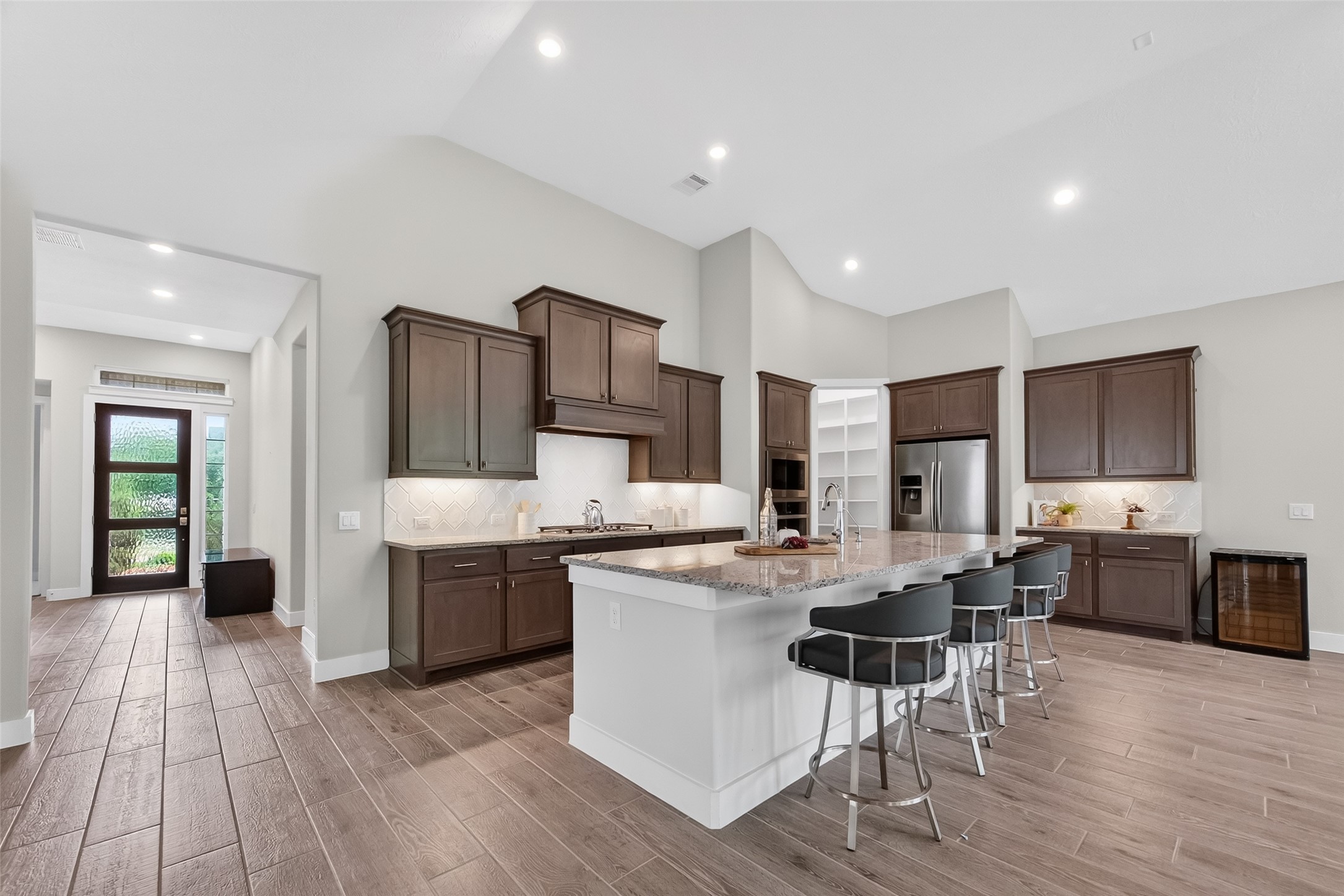 3415 Mckinney Ridge Drive Houston, TX 77059 - Photo 20 of 43 a kitchen with stainless steel appliances kitchen island granite countertop a stove top oven a sink a dining table and chairs