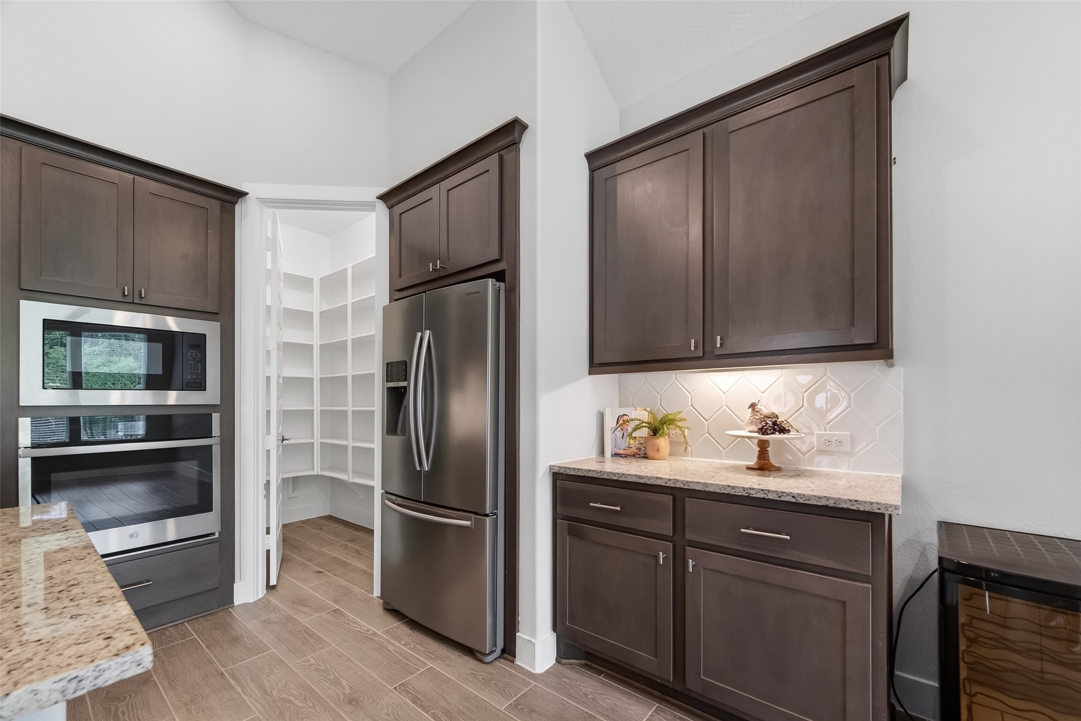 3415 Mckinney Ridge Drive Houston, TX 77059 - Photo 21 of 43 a kitchen with stainless steel appliances wooden cabinets and a refrigerator