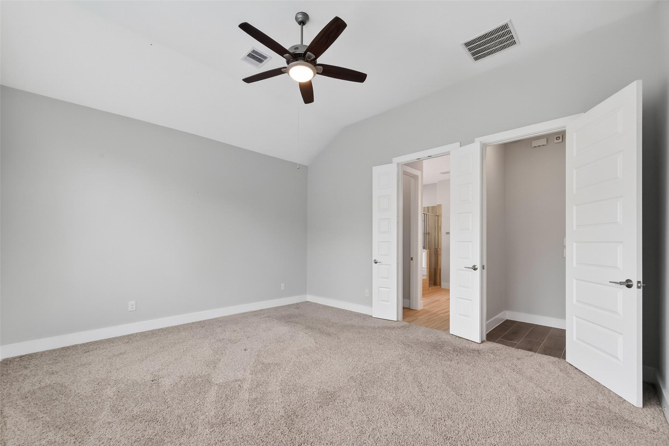 3415 Mckinney Ridge Drive Houston, TX 77059 - Photo 22 of 43 The primary bedroom features a spacious layout. It includes a ceiling fan for comfort and double doors leading to the gorgeous ensuite bath.