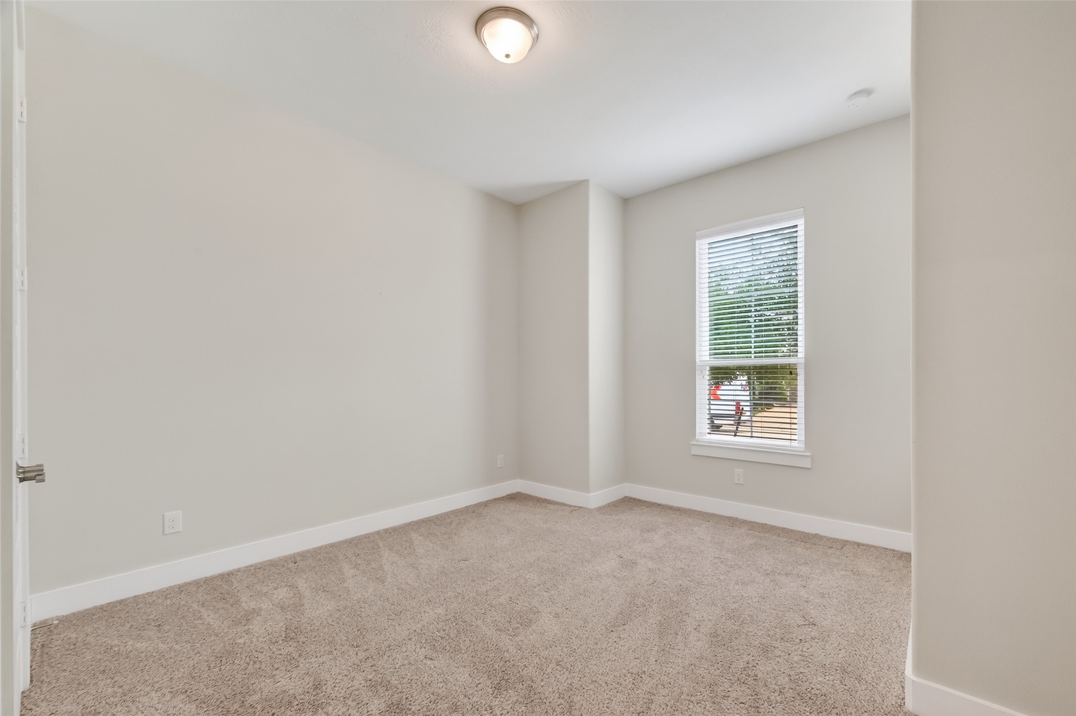 3415 Mckinney Ridge Drive Houston, TX 77059 - Photo 32 of 43 This is a bright bedroom has neutral-color walls and carpet flooring. It features a window with 2" wood blinds.
