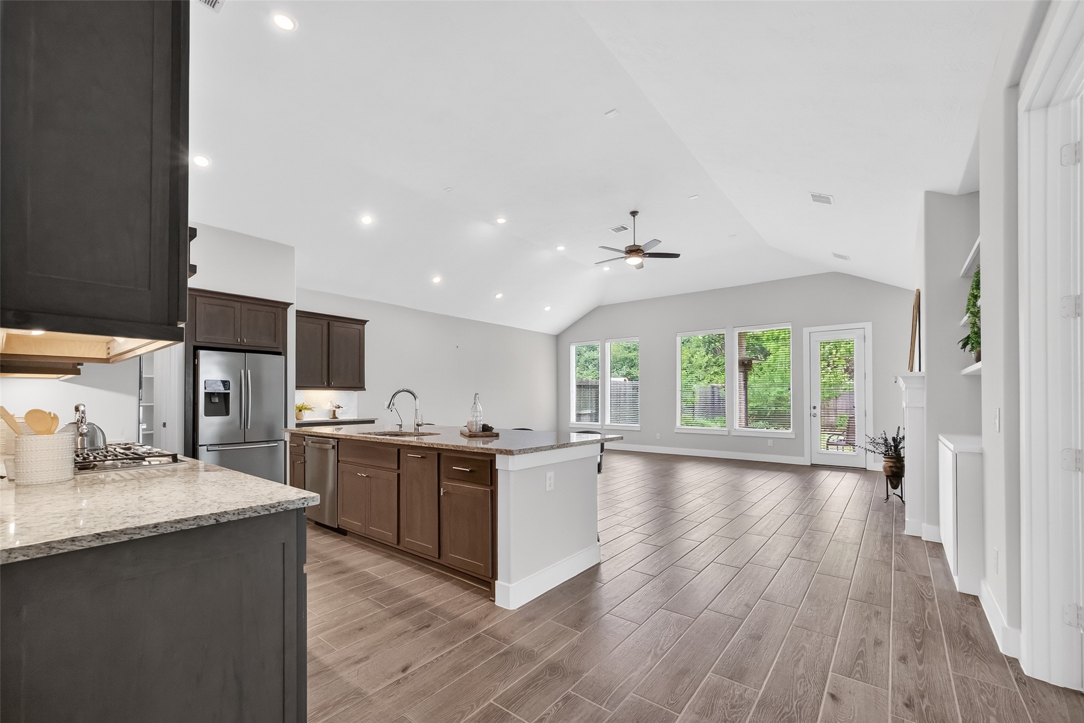 3415 Mckinney Ridge Drive Houston, TX 77059 - Photo 6 of 43 a kitchen with stainless steel appliances granite countertop a stove top oven a sink dishwasher and a refrigerator with wooden floor