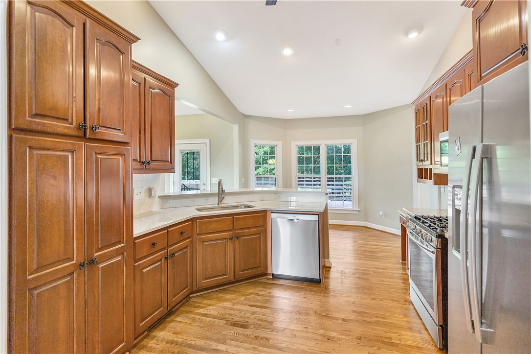 3620 Centerville Road Anderson, SC 29625 - Photo 30 of 49 Rich wood cabinetry pairs with stainless steel appliances under vaulted ceilings.