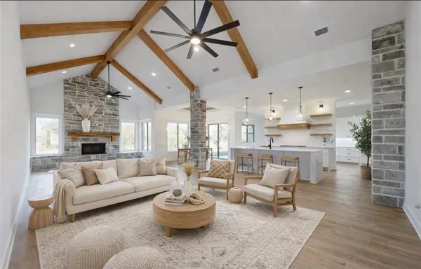a view of a kitchen with kitchen island stainless steel appliances wooden floor and window