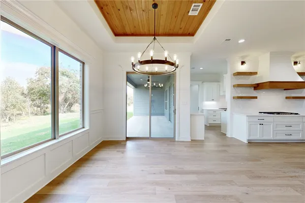 a kitchen with stainless steel appliances granite countertop a sink stove and cabinets