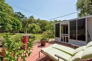 a view of a patio with table and chairs and potted plants