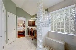 a bathroom with a bathtub sink and mirror