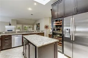 a kitchen with stainless steel appliances granite countertop a kitchen island a cabinets and wooden floor