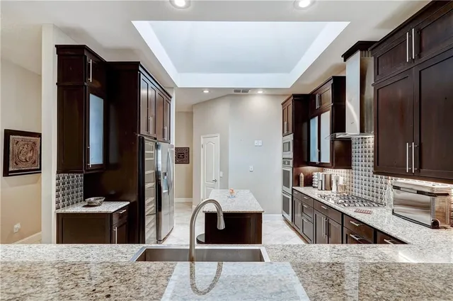 a living room with furniture rug and wall painting