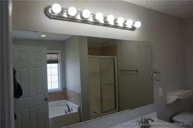 a bathroom with a glass shower door