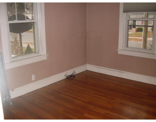 27 Eloise Street Springfield, MA 01118 - Photo 5 of 9 an empty room with wooden floor and windows
