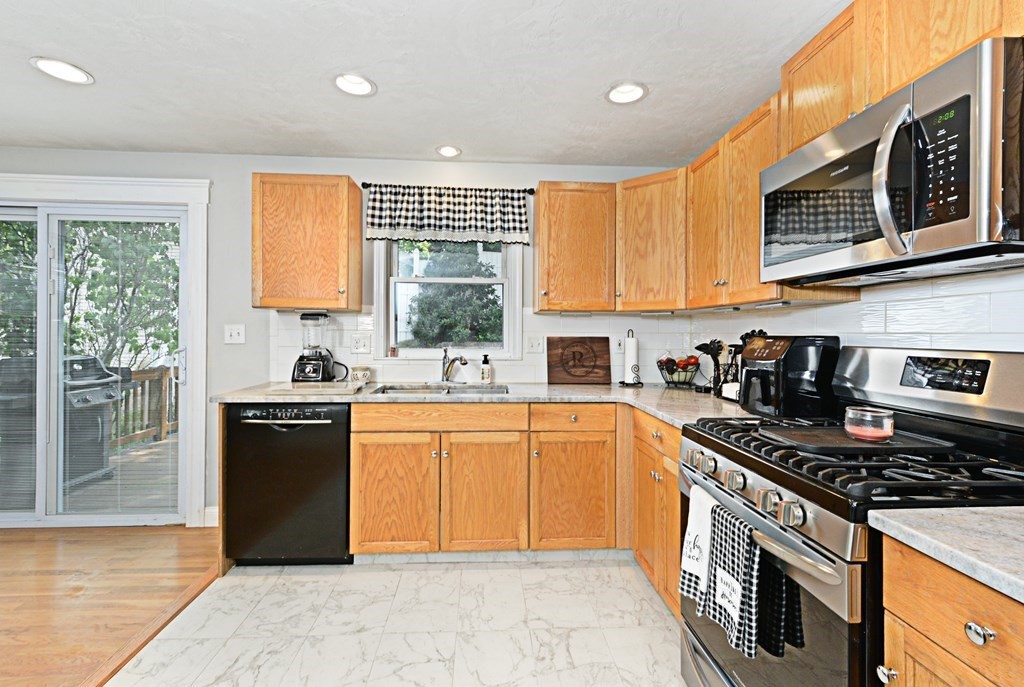 1 Hapgood Road Worcester, MA 01605 - Photo 11 of 34 a kitchen with stainless steel appliances granite countertop a stove sink and cabinets