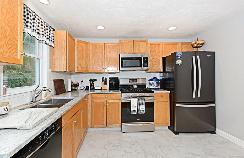 1 Hapgood Road Worcester, MA 01605 - Photo 12 of 34 a kitchen with stainless steel appliances granite countertop a refrigerator stove and sink