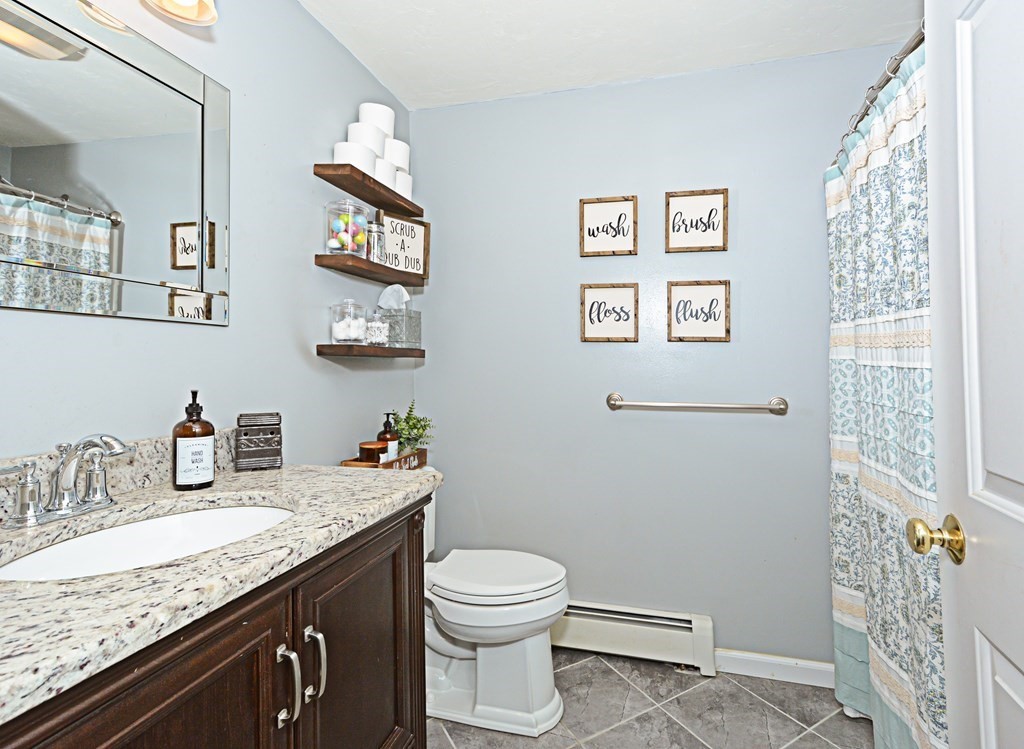 1 Hapgood Road Worcester, MA 01605 - Photo 18 of 34 a bathroom with a granite countertop sink mirror vanity and toilet