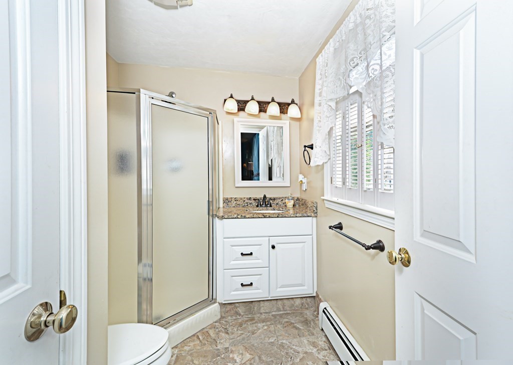 1 Hapgood Road Worcester, MA 01605 - Photo 22 of 34 a bathroom with a granite countertop sink mirror vanity and toilet