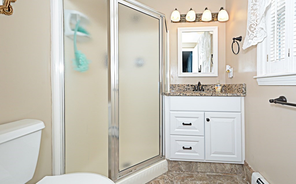 1 Hapgood Road Worcester, MA 01605 - Photo 23 of 34 a bathroom with a sink a toilet and a mirror