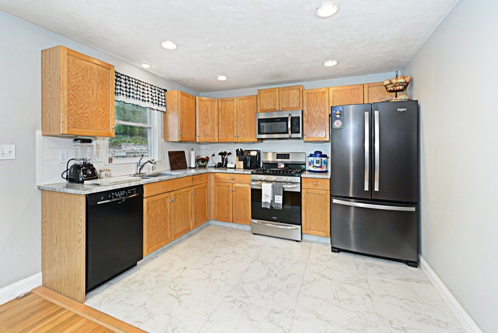 1 Hapgood Road Worcester, MA 01605 - Photo 9 of 34 a kitchen with stainless steel appliances granite countertop a refrigerator sink and cabinets