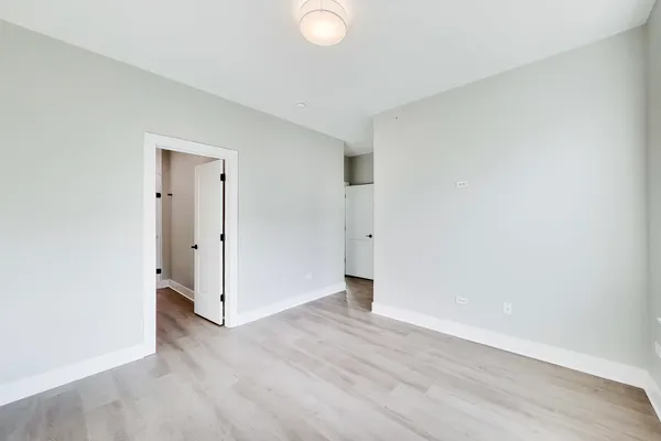 a view of an empty room and wooden floor