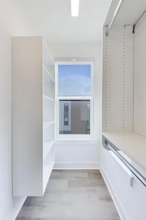 a view of an empty room with a fireplace and a window